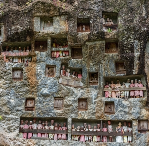 Rock tombs and galleries of Tau Tau in the steep rock face of the burial site of Lemo in Tana Toraja on Sulawesi. The Tau Tau symbolize the continuation of the life of the deceased in the afterlife.